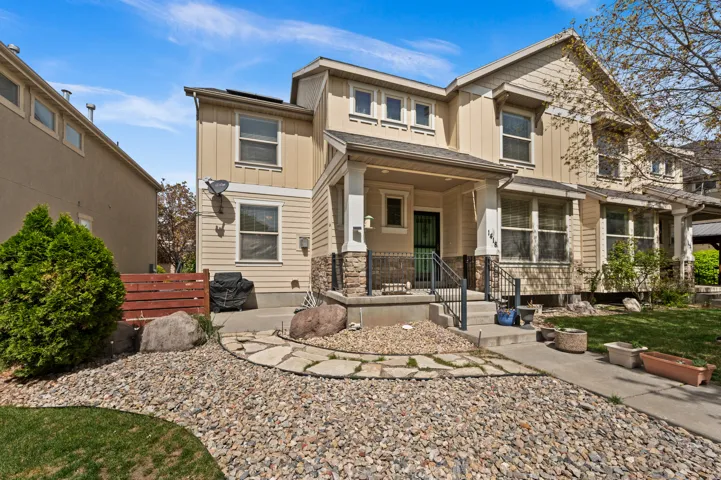 Craftsman-style house featuring board and batten siding, a porch, and stone siding