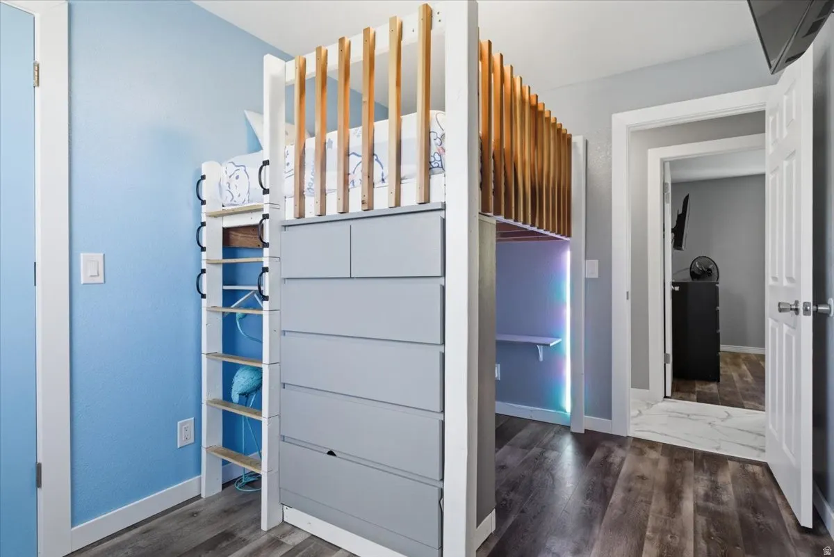 Unfurnished bedroom featuring dark wood-style floors