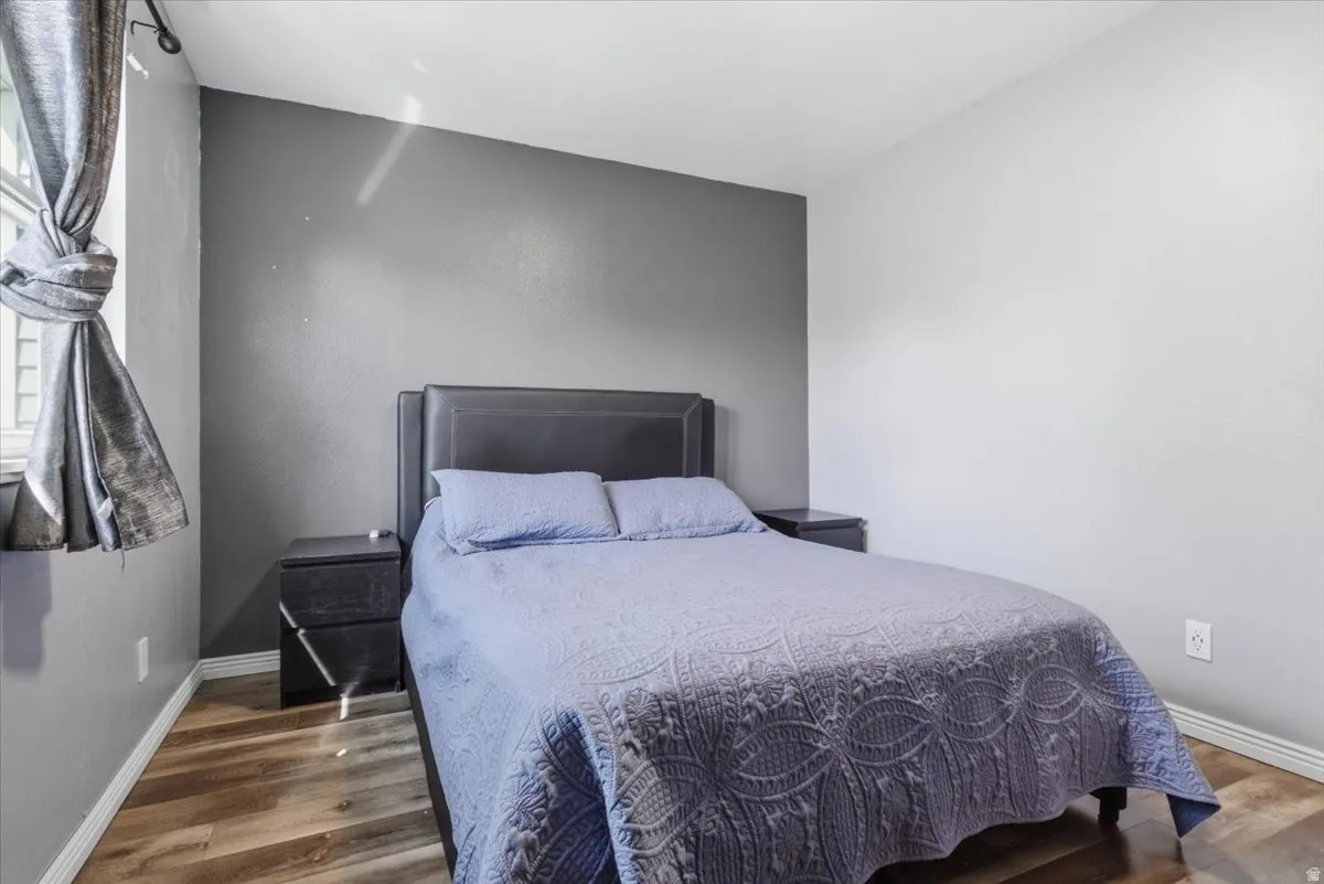 Bedroom featuring baseboards and wood finished floors