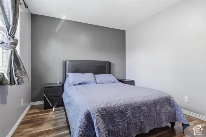 Bedroom featuring baseboards and wood finished floors