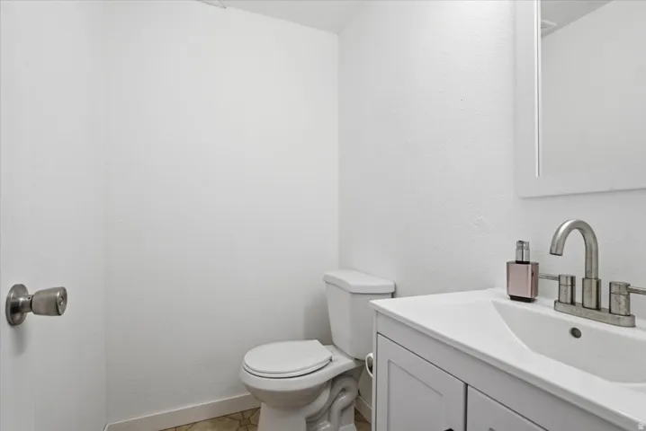 Half bath with vanity and toilet