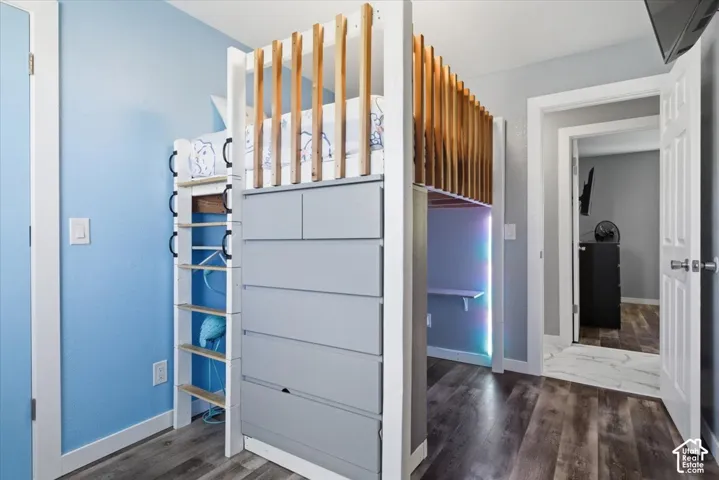 Unfurnished bedroom featuring dark wood-style floors