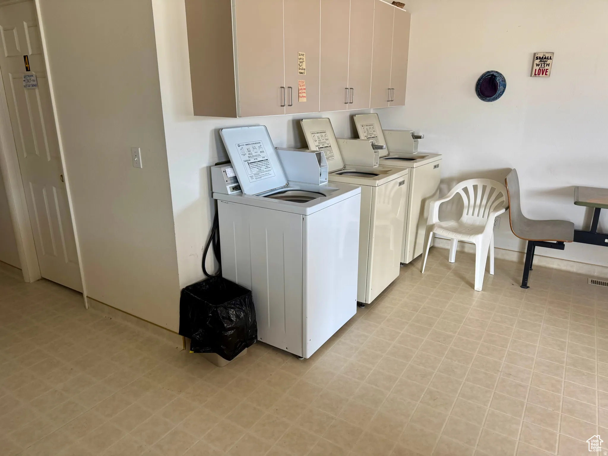 Shared laundry room with washing machine and dryer