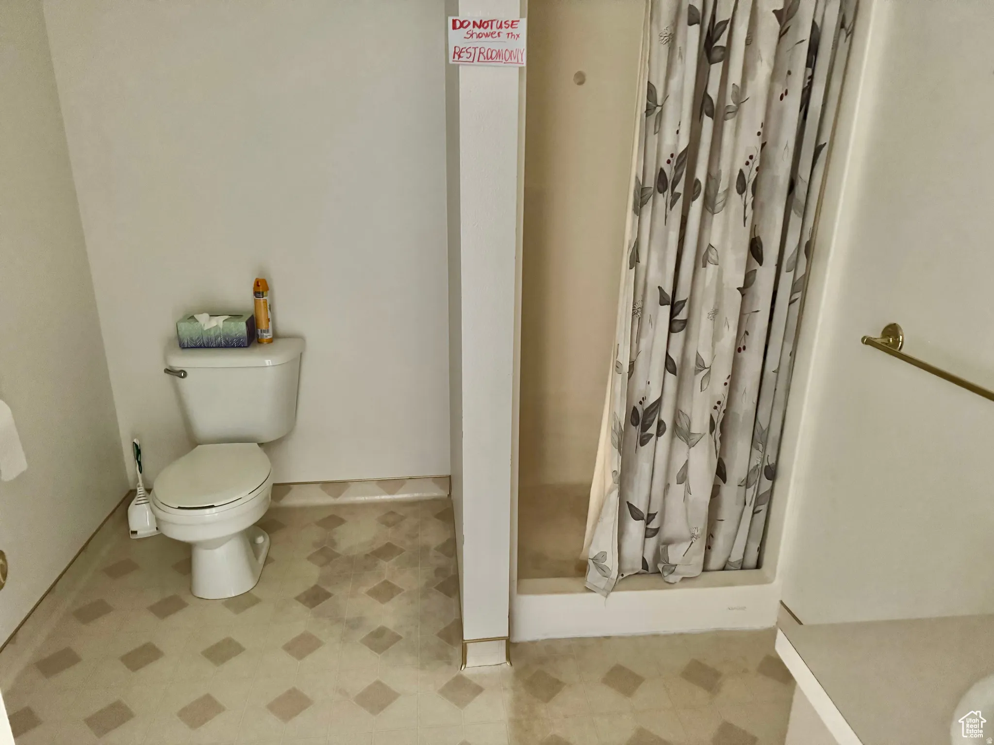 Bathroom with a shower stall and toilet