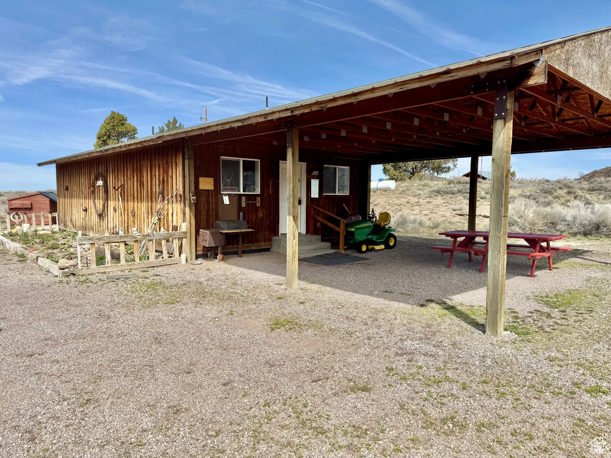 Back of property with an attached carport and entry steps