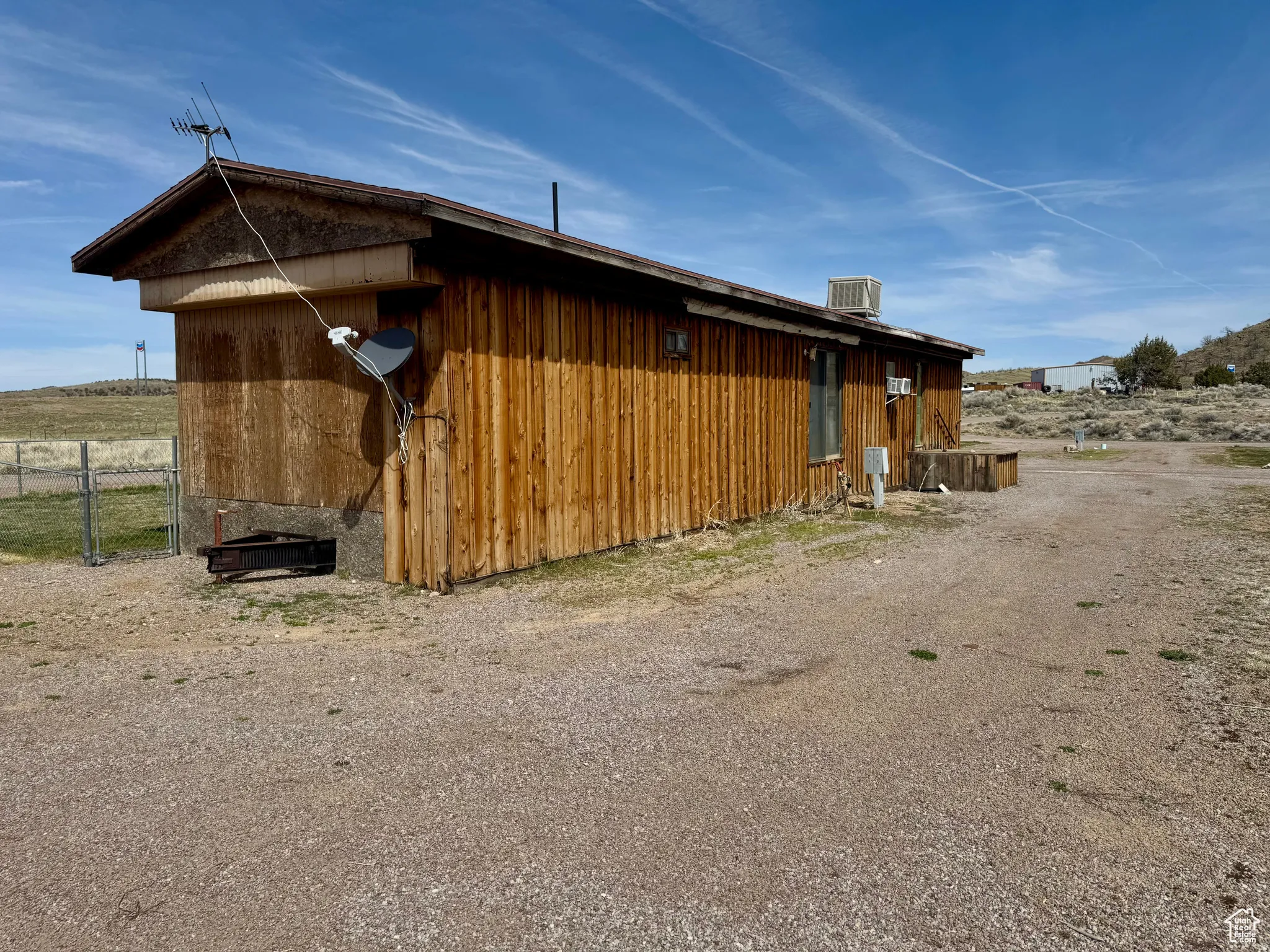 View of side of home with a central AC unit