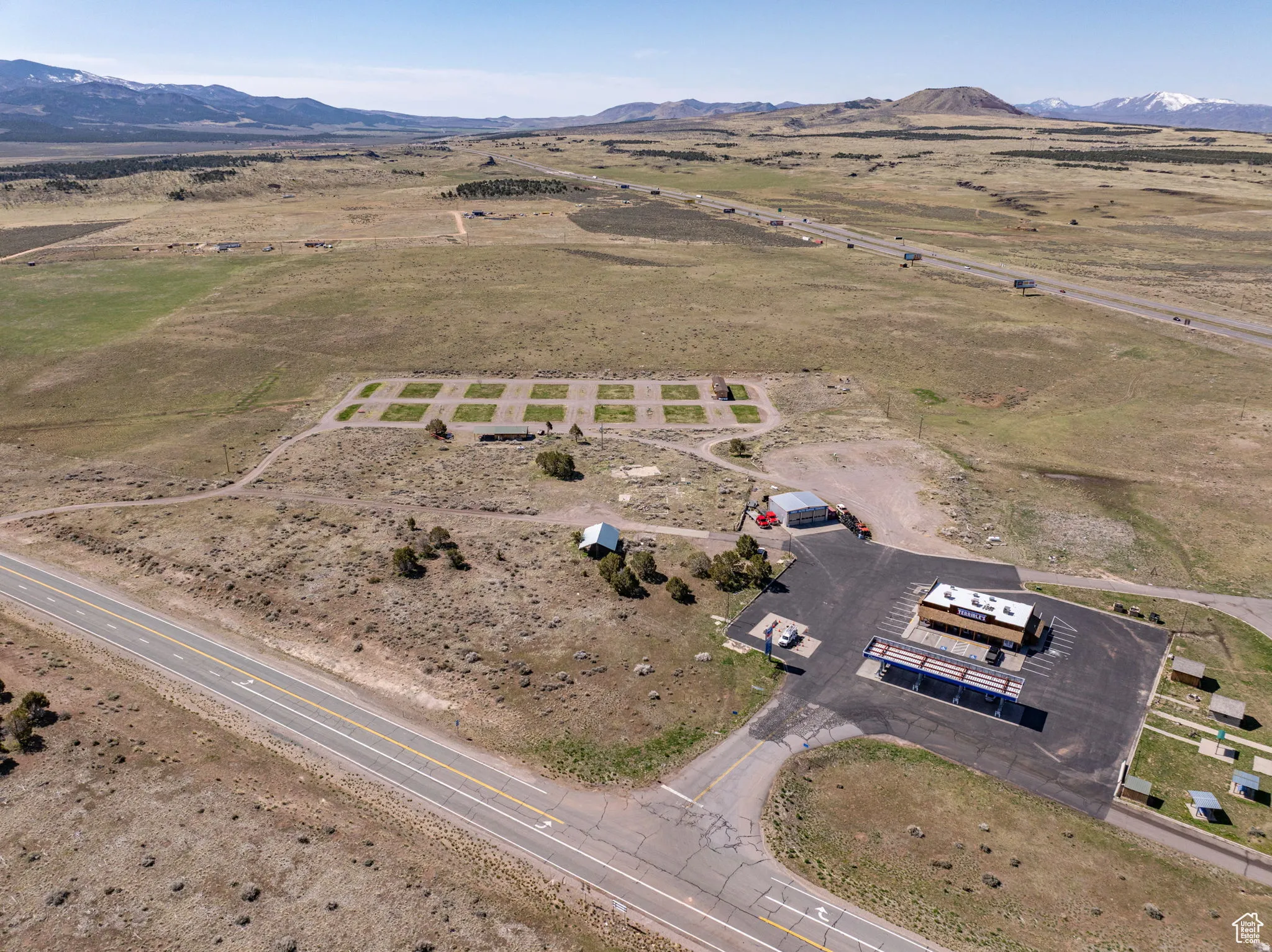 Aerial overview of property's location with rural landscape and mountains