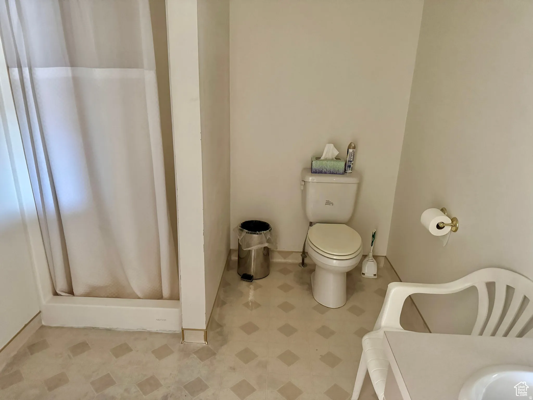 Full bath featuring a stall shower and toilet