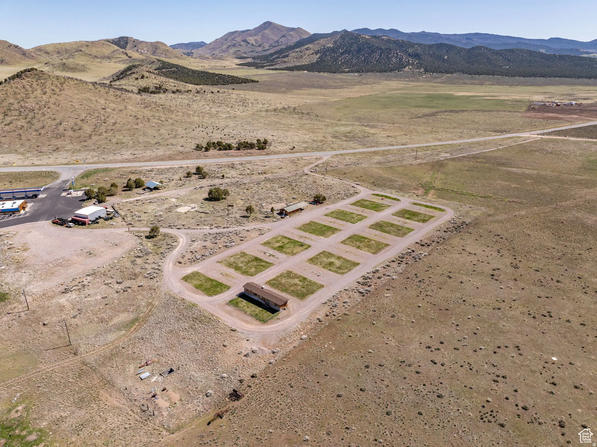 Aerial view of sparsely populated area with a mountain backdrop and a desert landscape