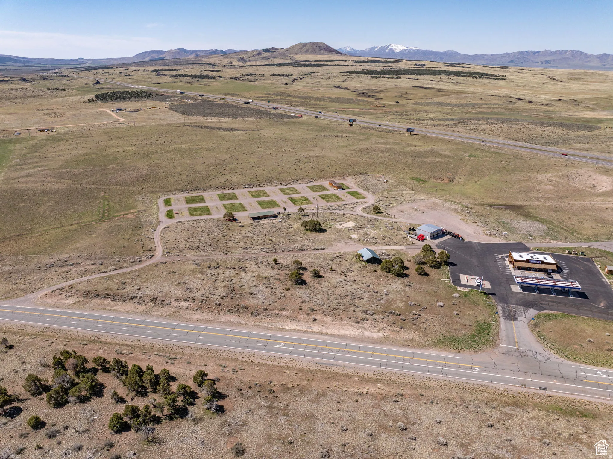 Aerial overview of property's location featuring rural landscape and a mountainous background