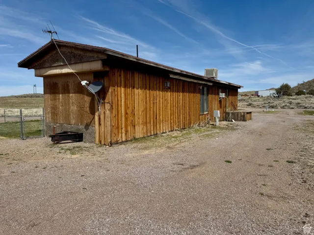 View of side of home with a central AC unit