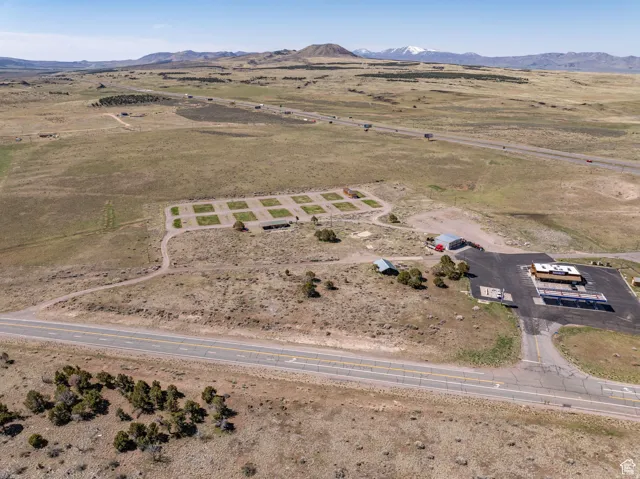 Aerial overview of property's location featuring rural landscape and a mountainous background