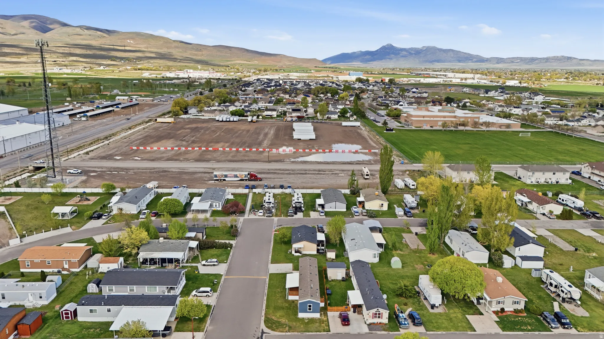 Aerial view of property and surrounding area featuring nearby suburban area and property boundaries highlighted