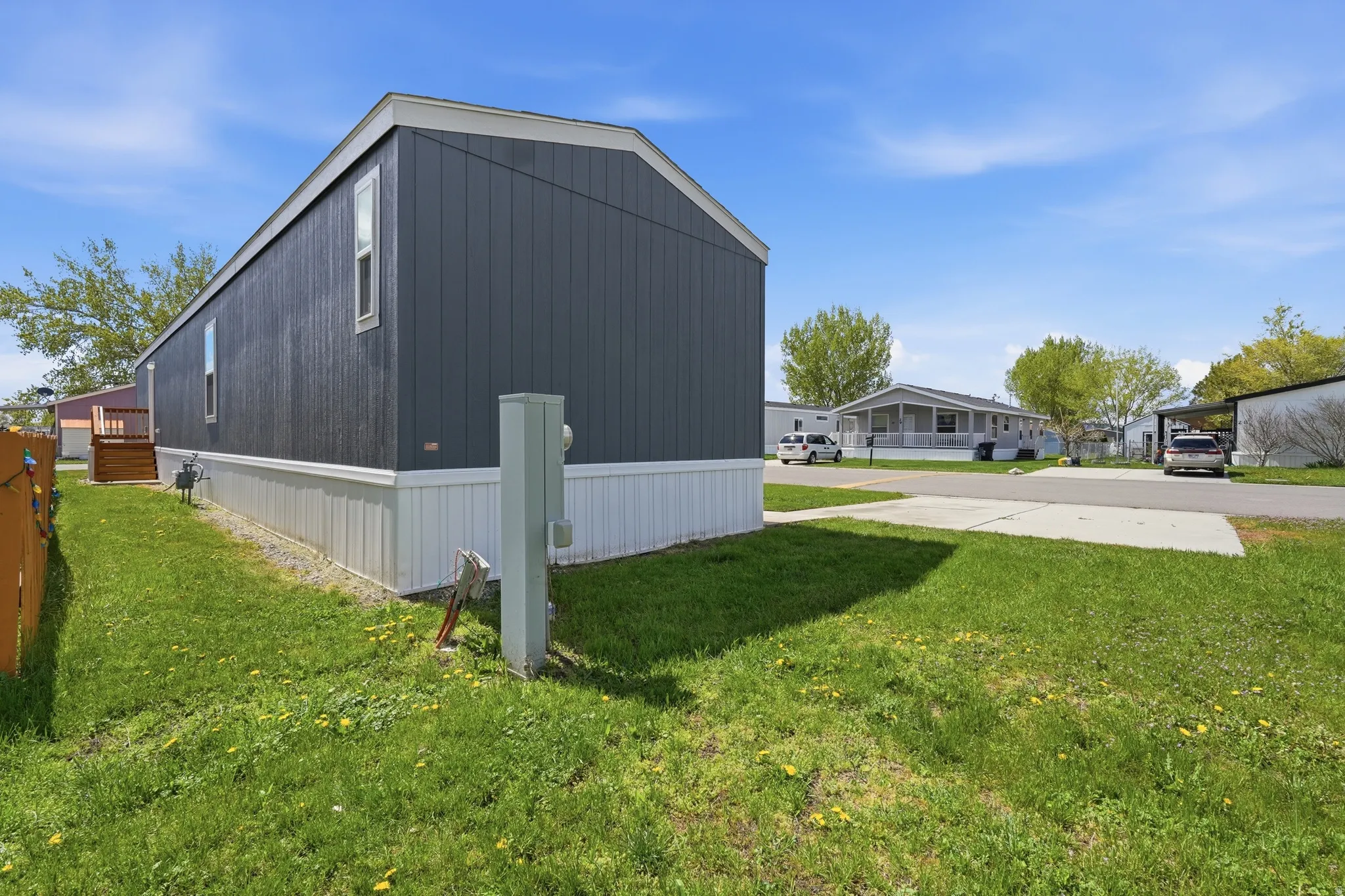 View of side of property featuring a lawn
