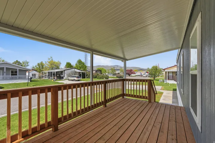Porch featuring a residential view and a yard