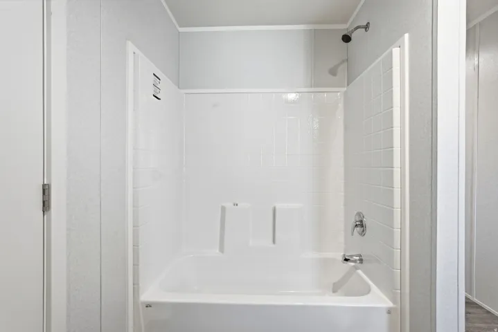 Bathroom featuring tub / shower combination and crown molding