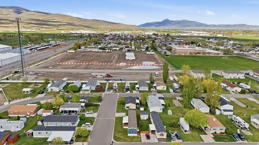 Aerial view of property and surrounding area featuring nearby suburban area and property boundaries highlighted