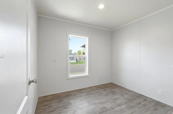 Empty room featuring light wood-style floors, recessed lighting, and crown molding