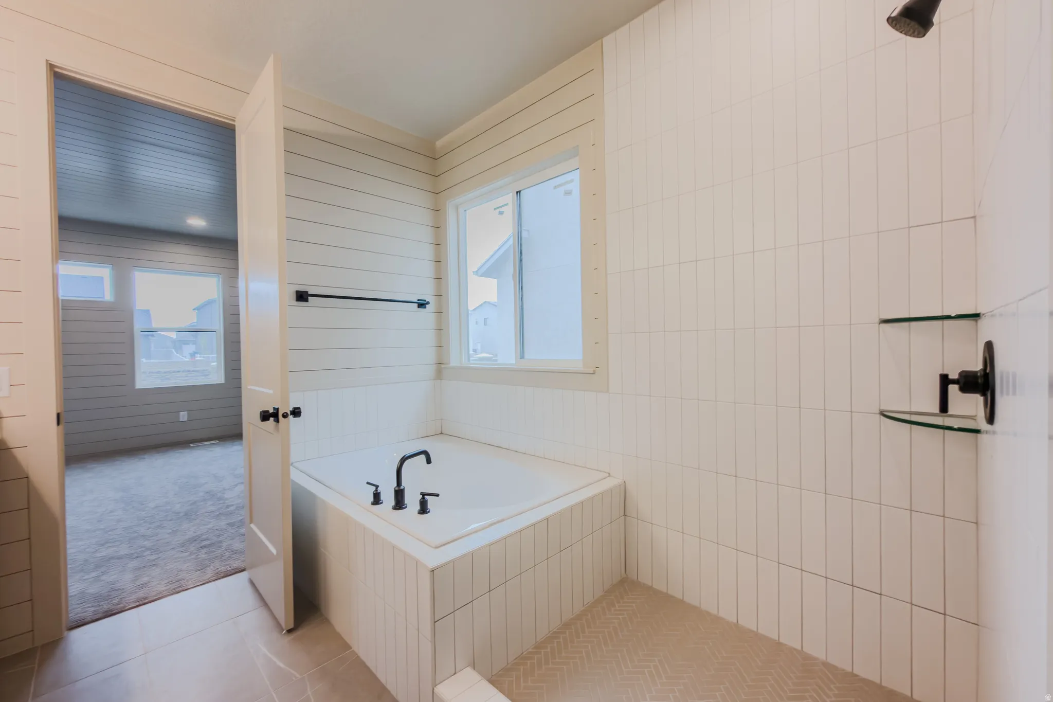 Full bathroom with a garden tub, light tile patterned flooring, and a tile shower
