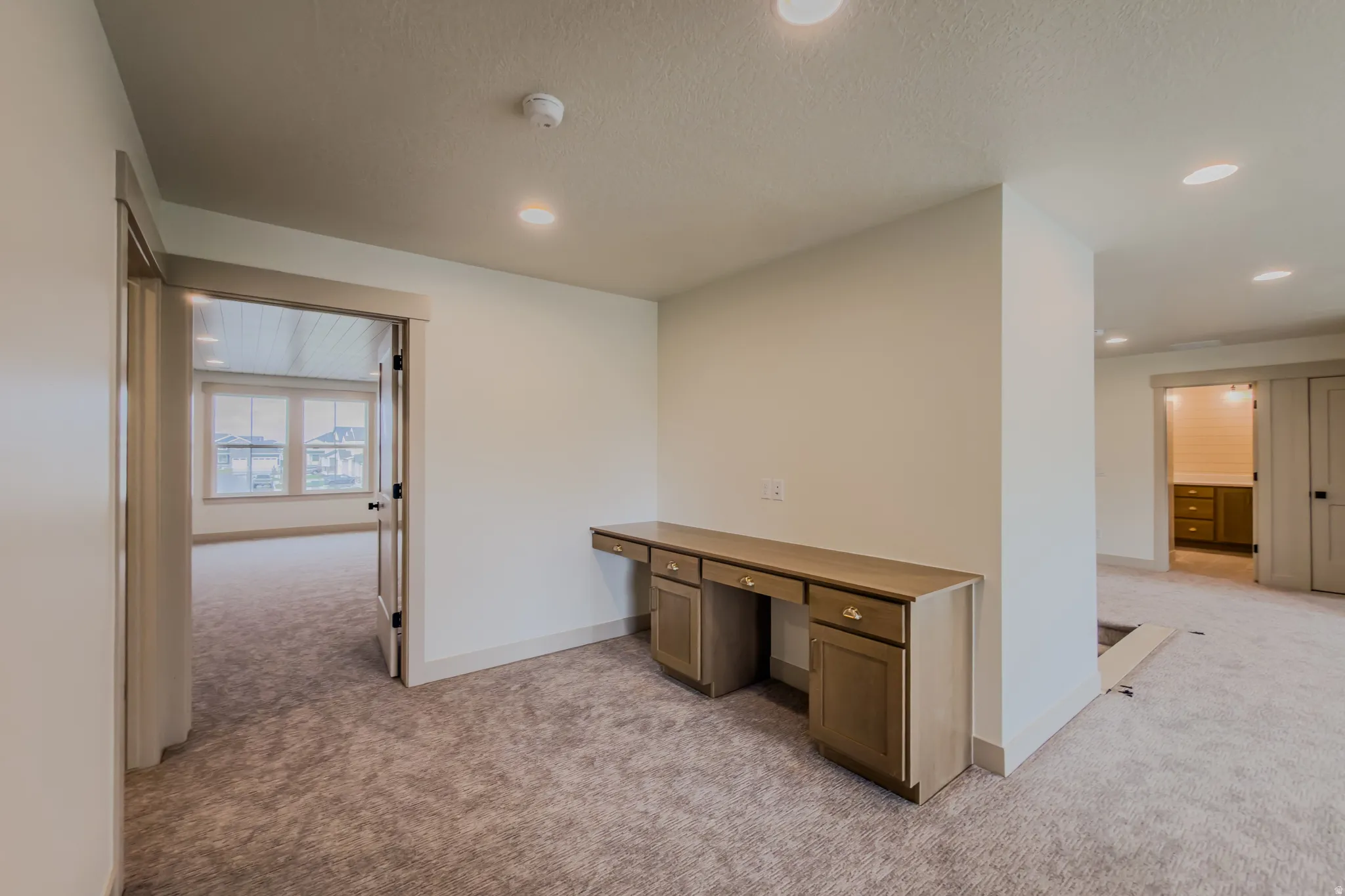 Unfurnished office featuring light carpet and recessed lighting