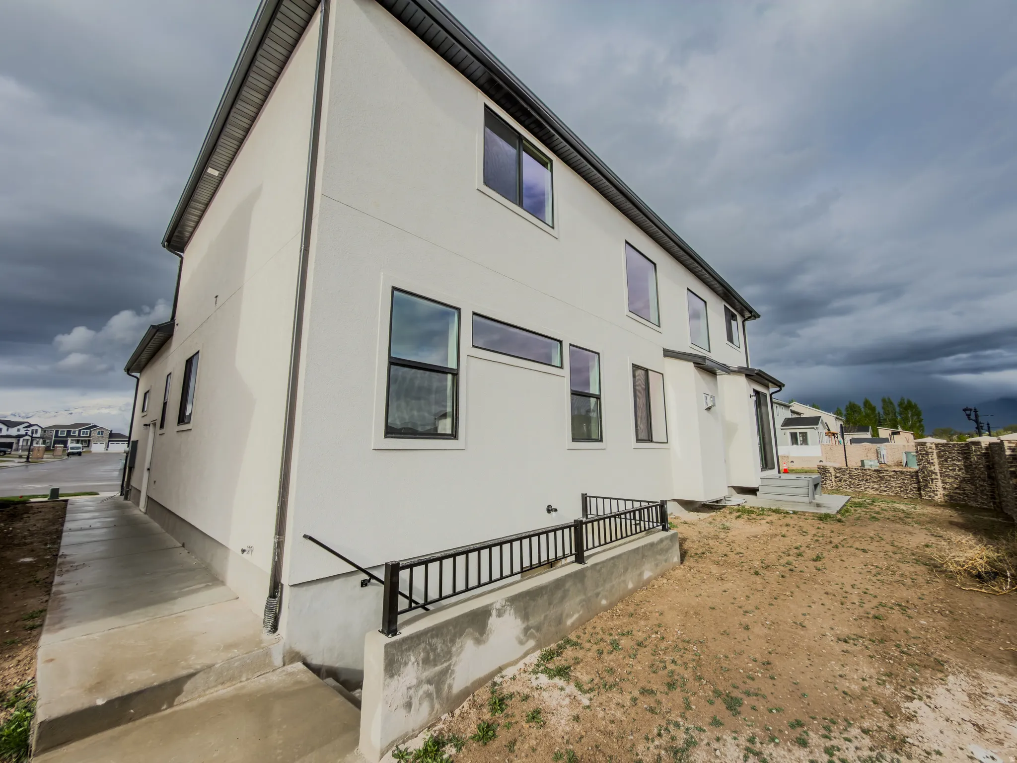 Rear view of house with stucco siding