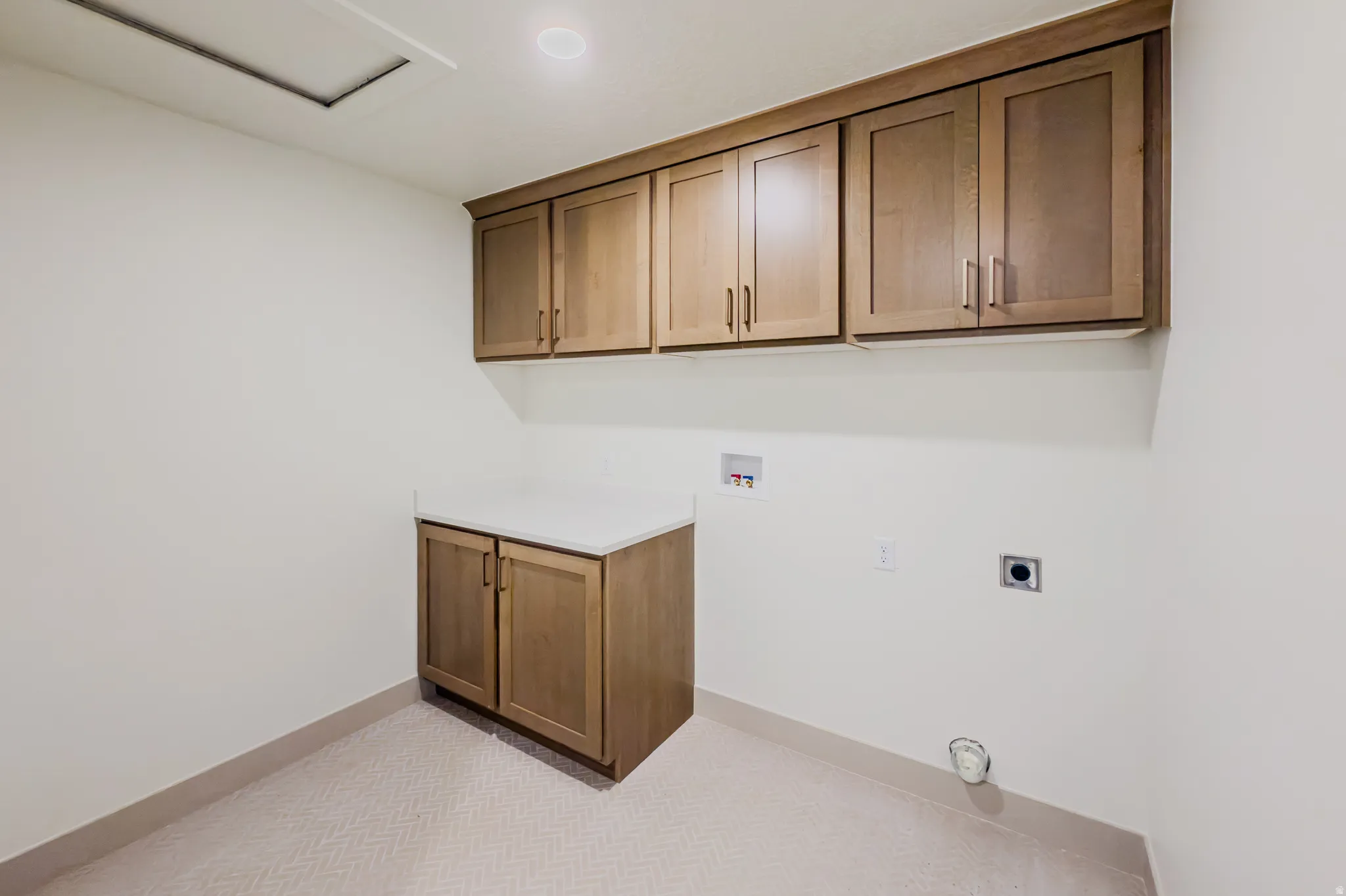 Laundry area featuring washer hookup, cabinet space, electric dryer hookup, and light carpet