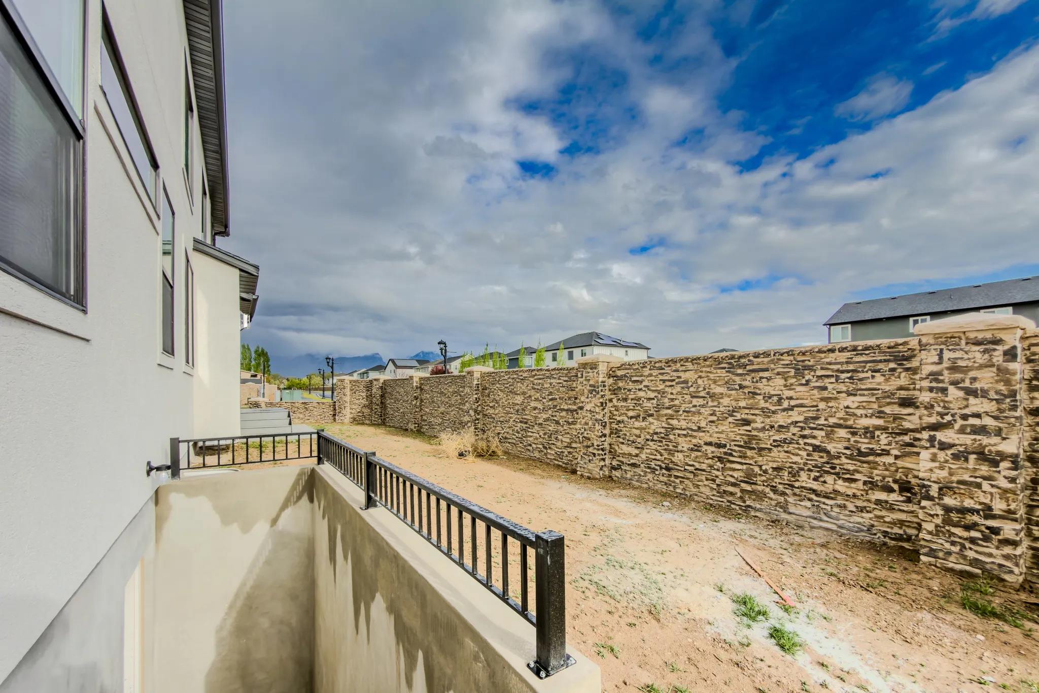 Fenced yard featuring a residential view