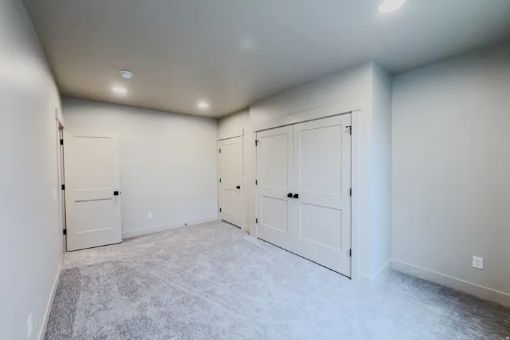 Unfurnished bedroom with light colored carpet, recessed lighting, and a closet