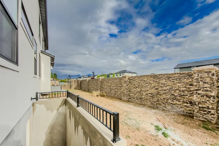 Fenced yard featuring a residential view