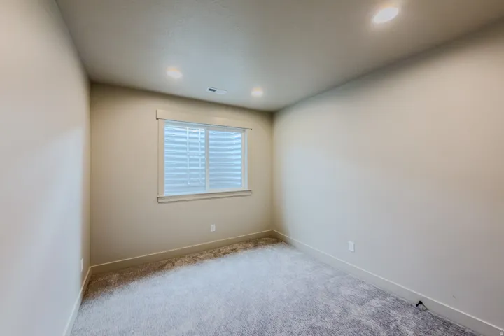 Spare room featuring light carpet and recessed lighting