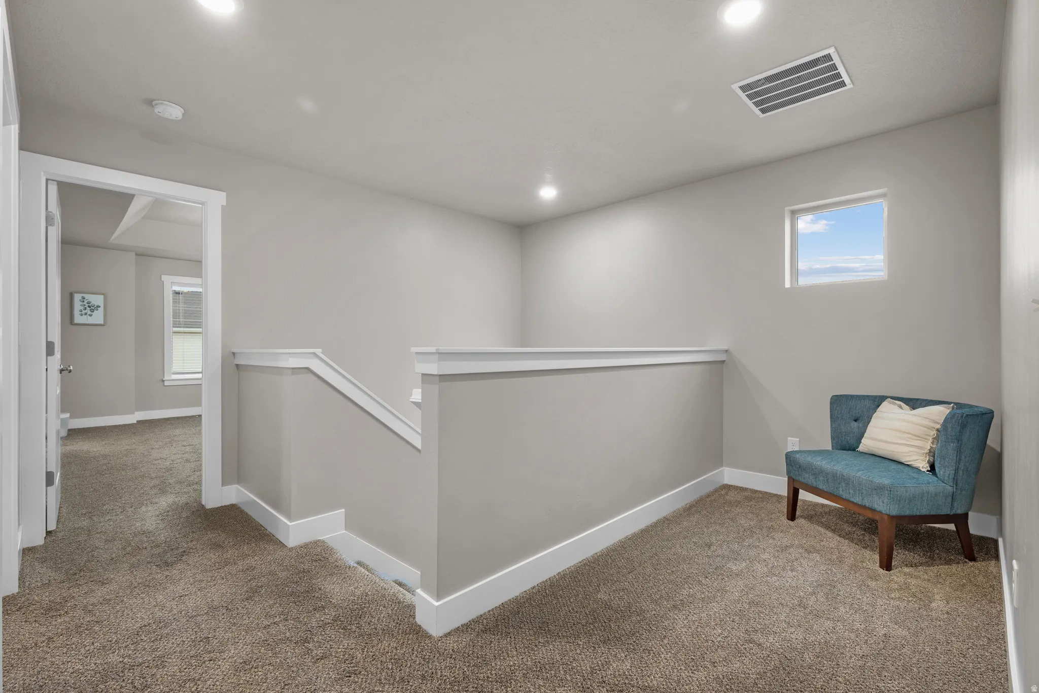 Sitting room featuring carpet floors, an upstairs landing, healthy amount of natural light, and recessed lighting