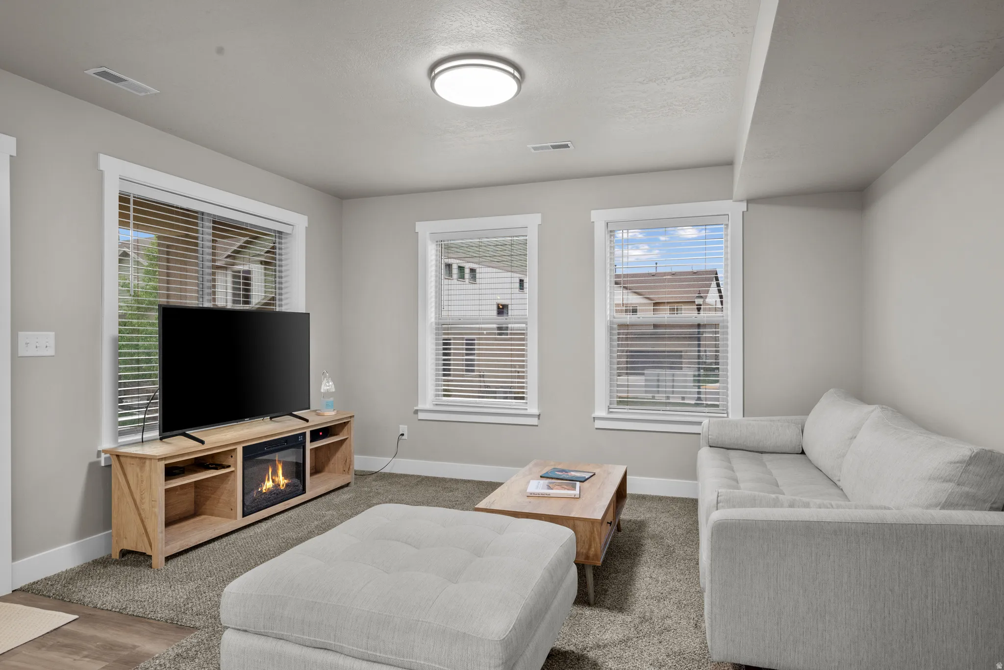 Living room featuring carpet flooring and a textured ceiling