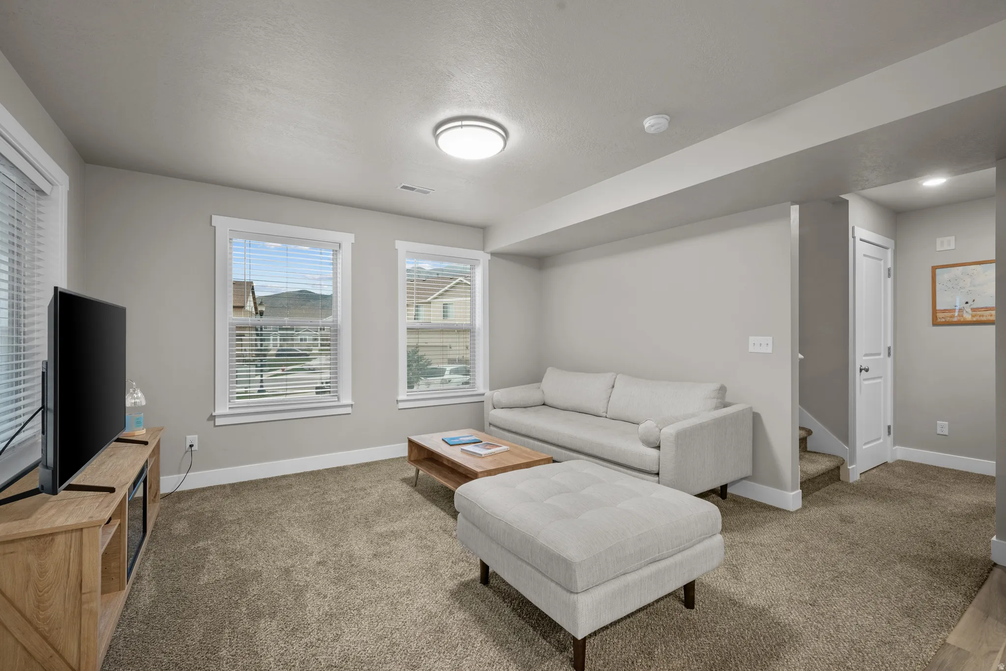 Carpeted living room with baseboards