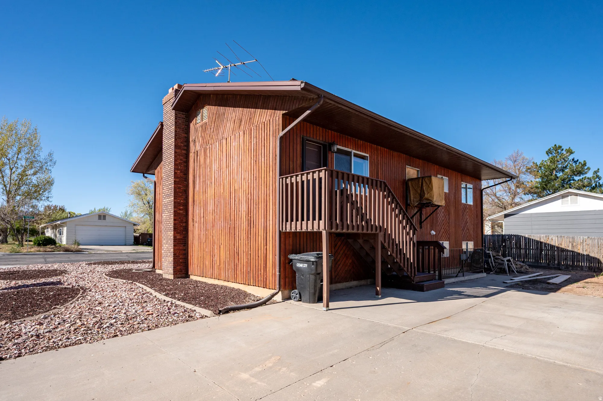 View of front of house featuring a wooden deck and a garage
