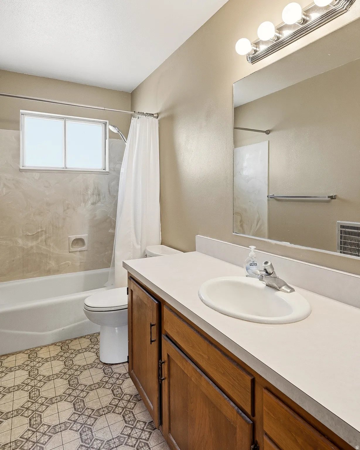 Bathroom with vanity and shower / bath combo