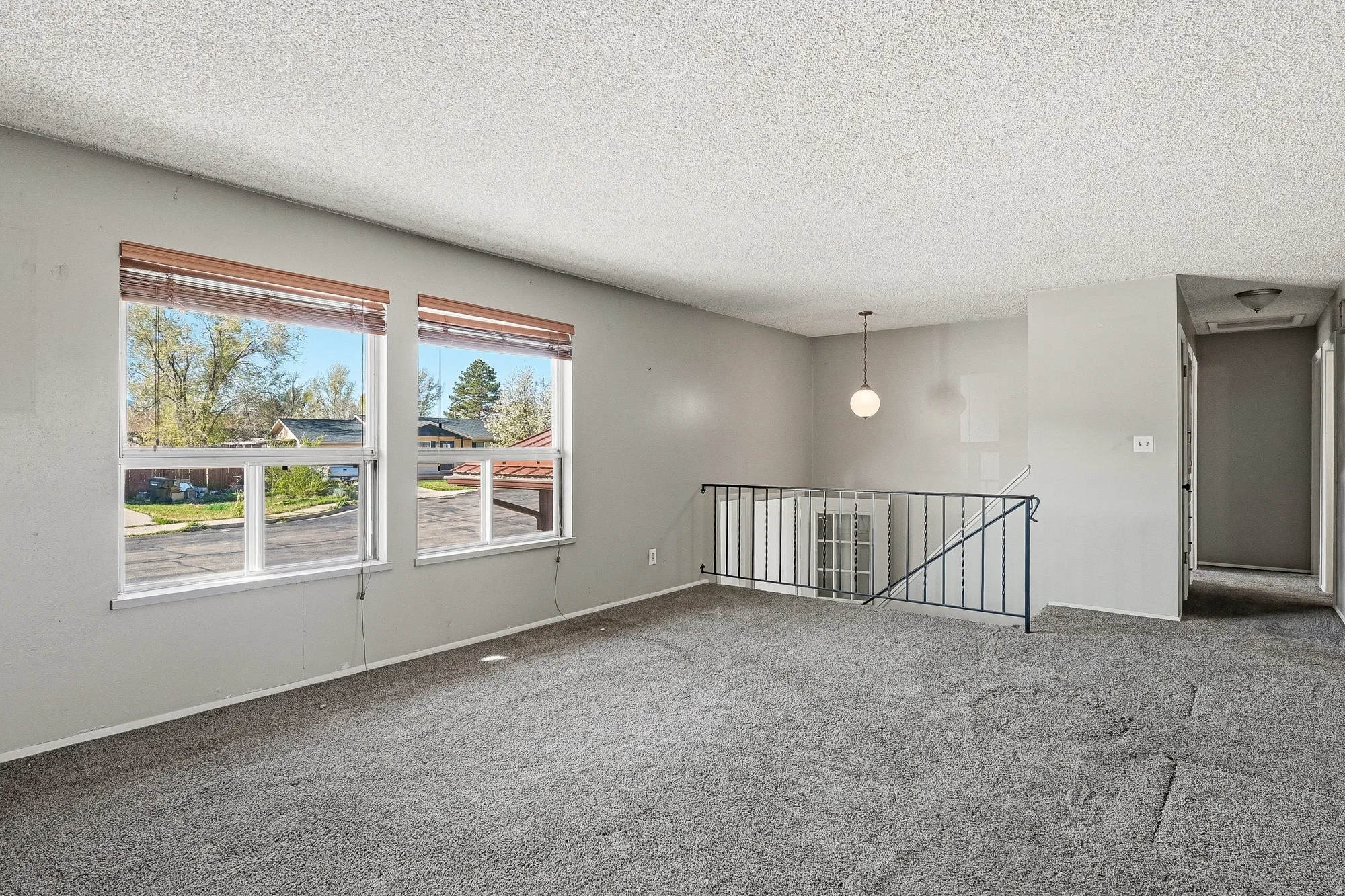 Unfurnished room with carpet and a textured ceiling