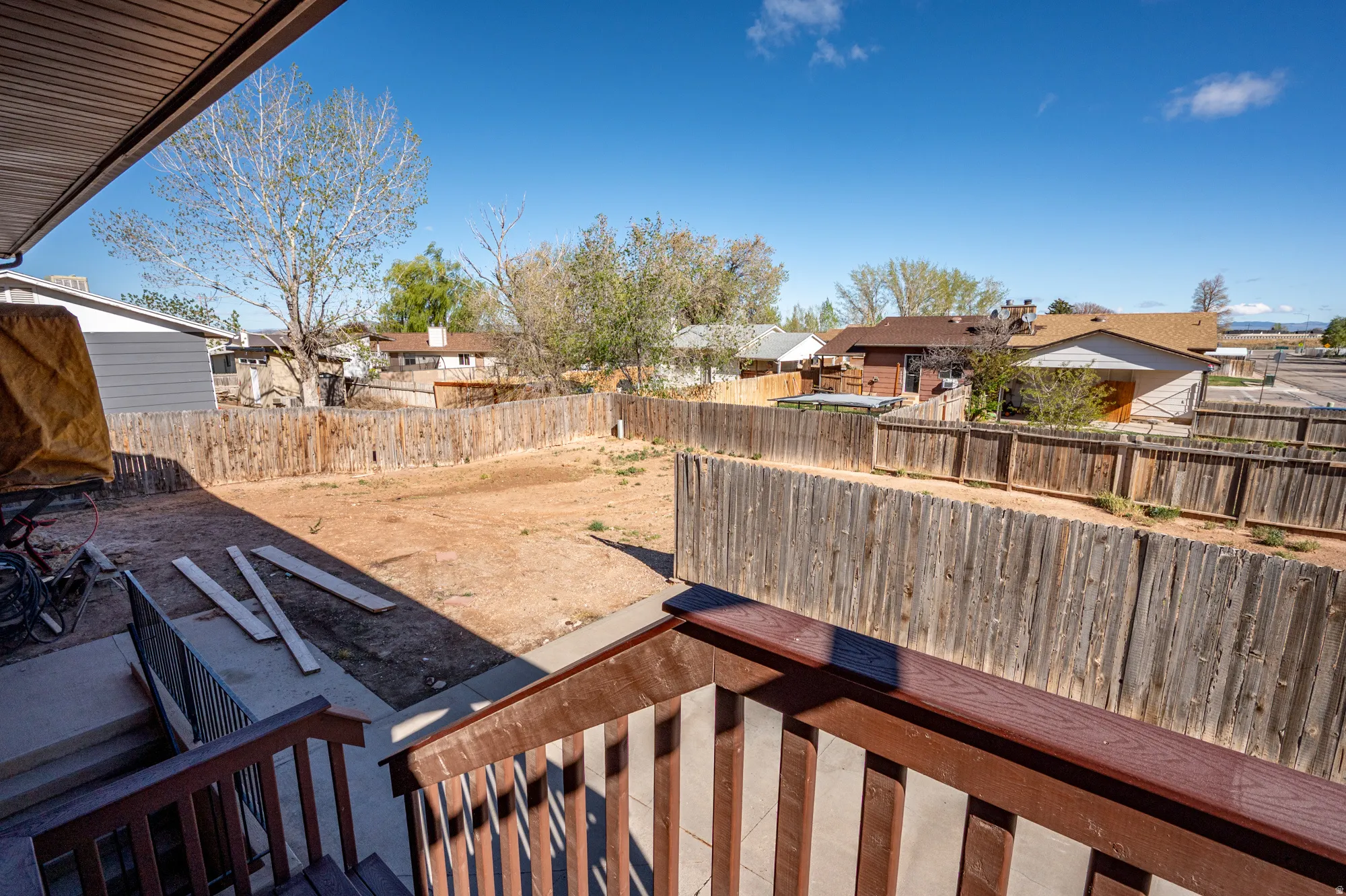 Fenced backyard with a residential view and a patio