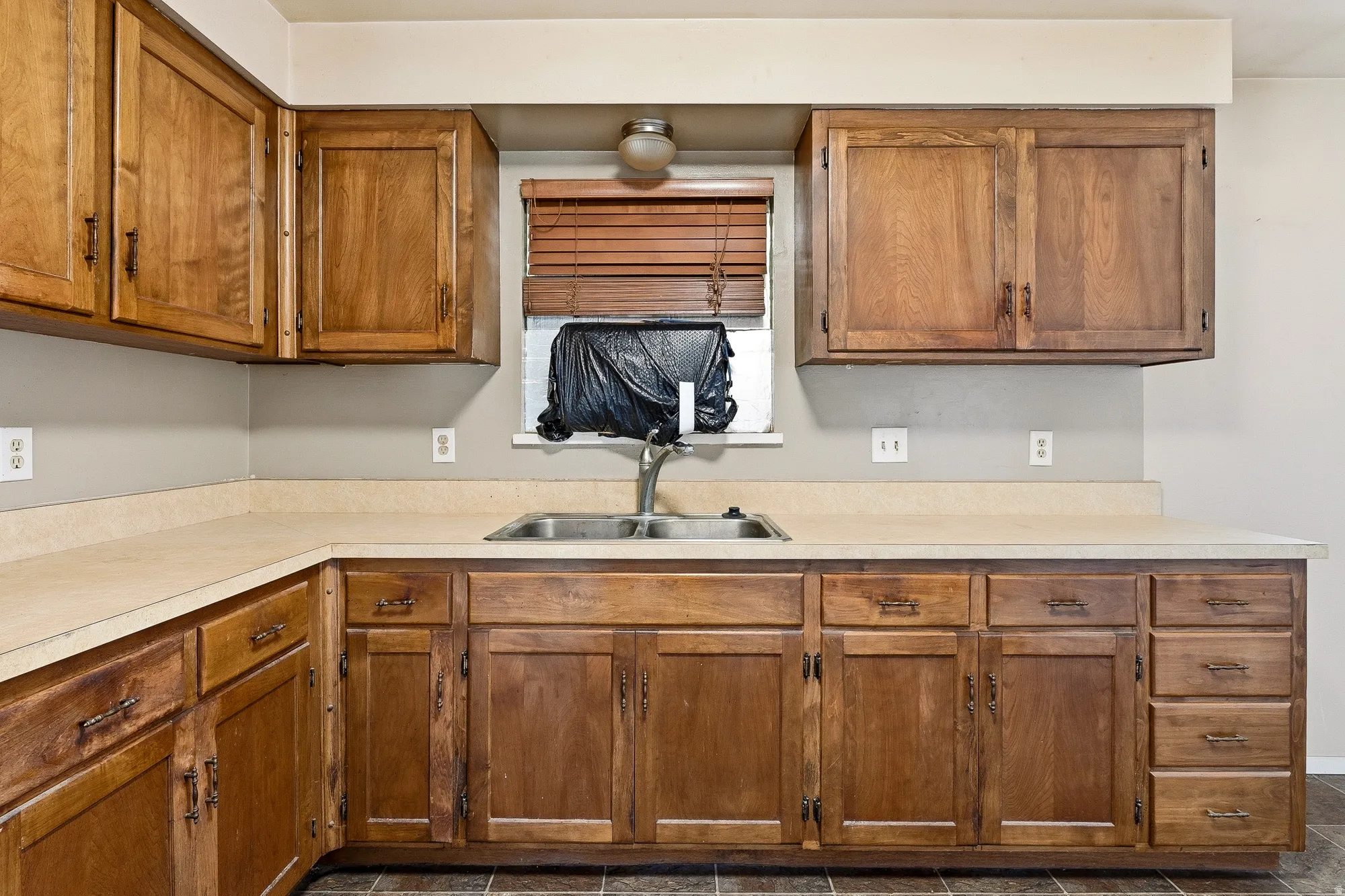 Kitchen with wood finish cabinetry and light countertops
