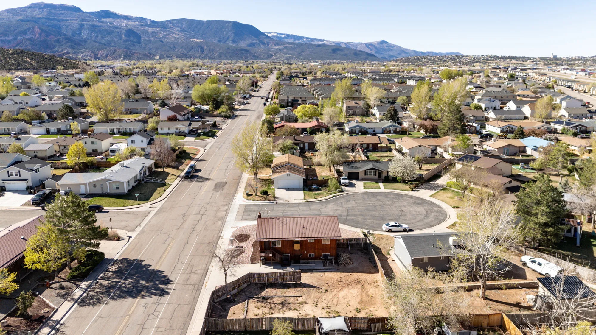 Aerial view of residential area featuring a mountainous background