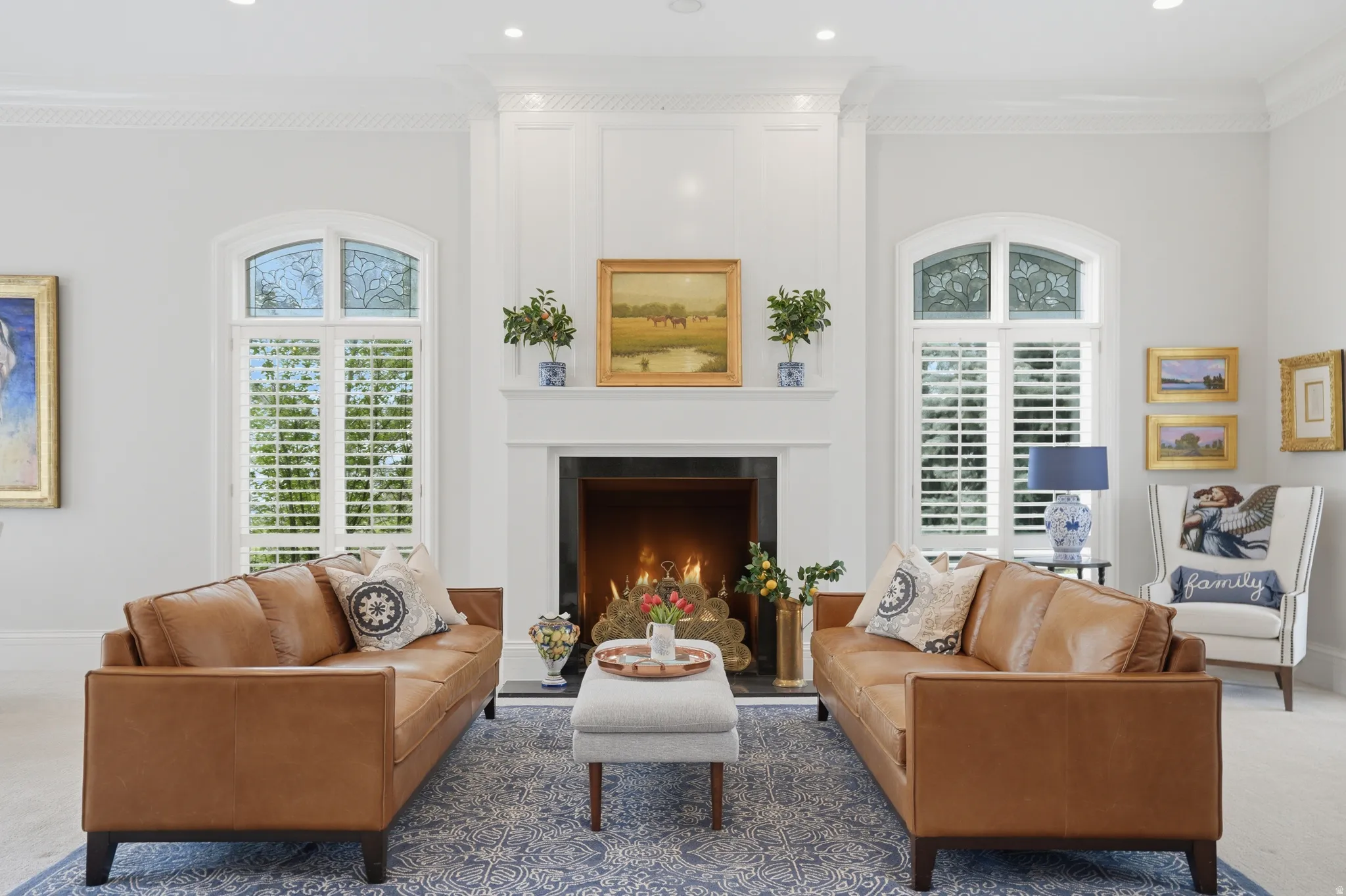 Living room with crown molding, custom paneling & natural light