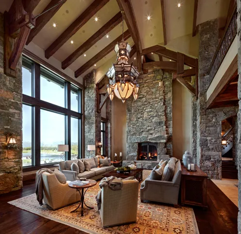 Living room featuring a fireplace, suspended lighting, hardwood / wood-style floors, and lofted ceiling