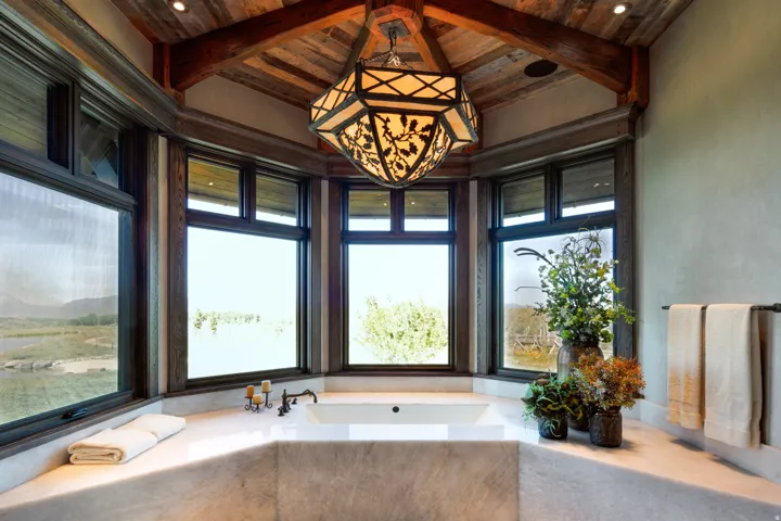 Bathroom featuring a bath and a wooden ceiling with exposed beams