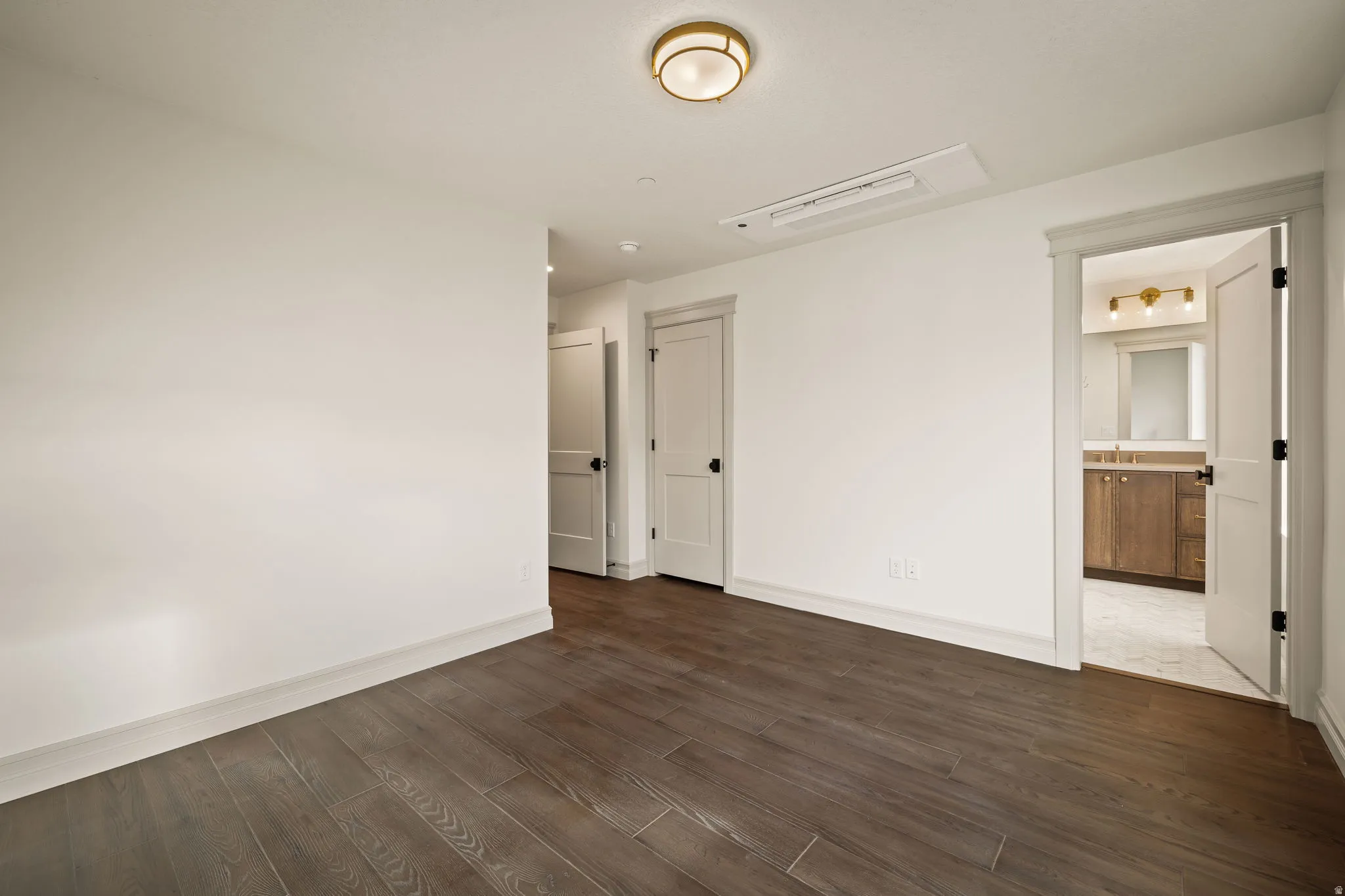 Unfurnished room featuring dark wood-type flooring and baseboards