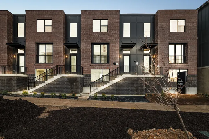 Contemporary home featuring brick siding