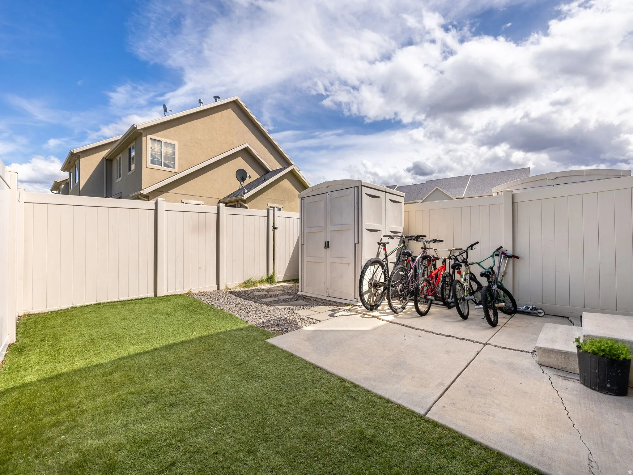 Fenced backyard with a storage shed
