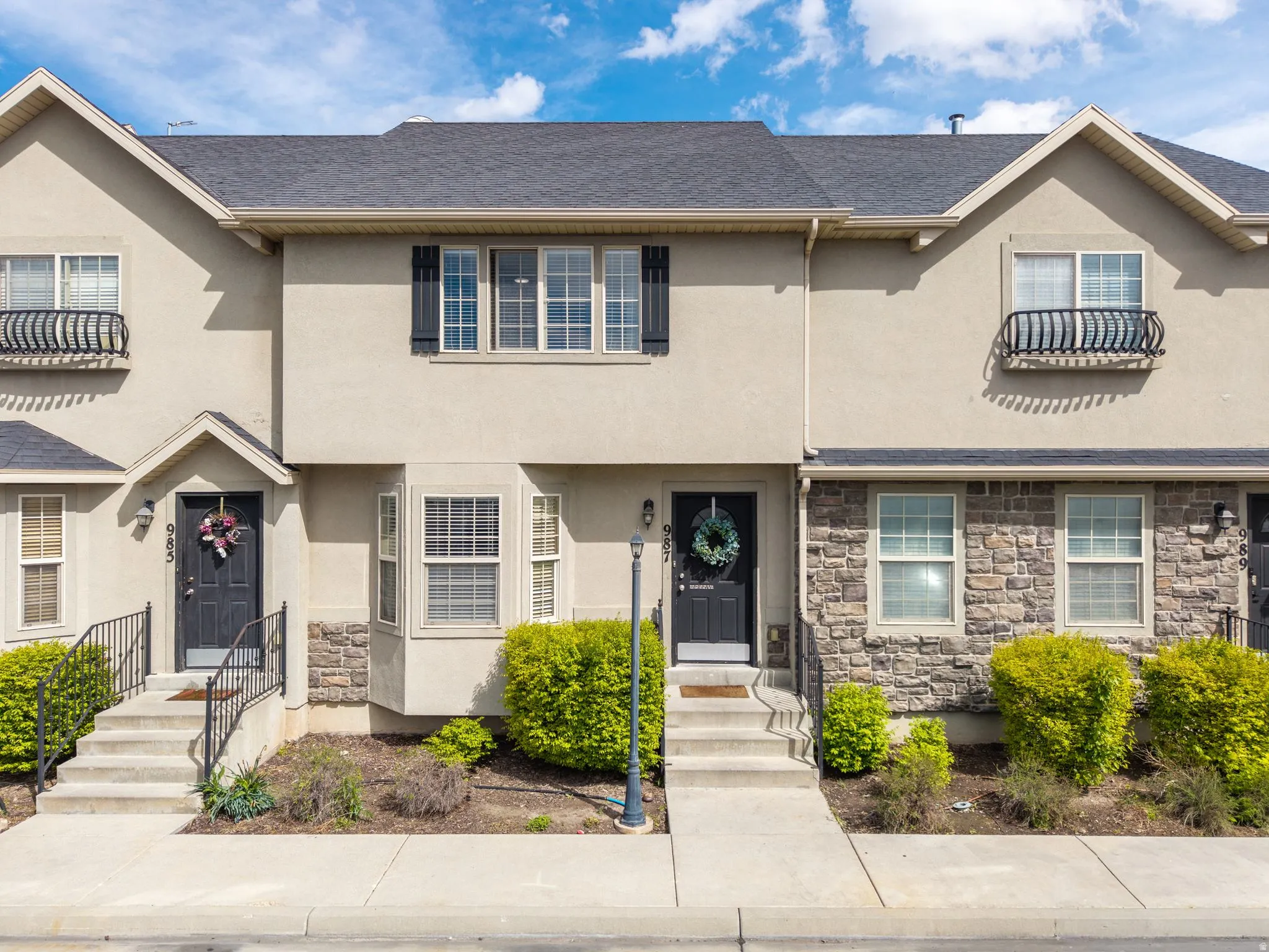 View of front of house featuring stone siding and stucco siding