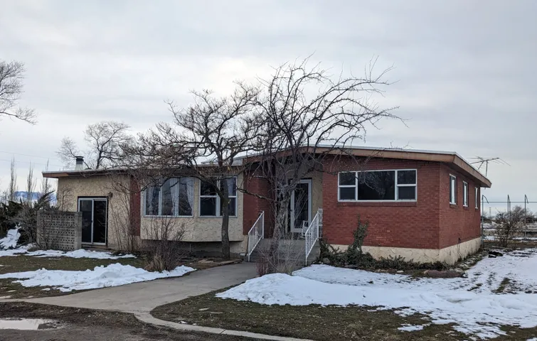 Bungalow-style house with brick siding