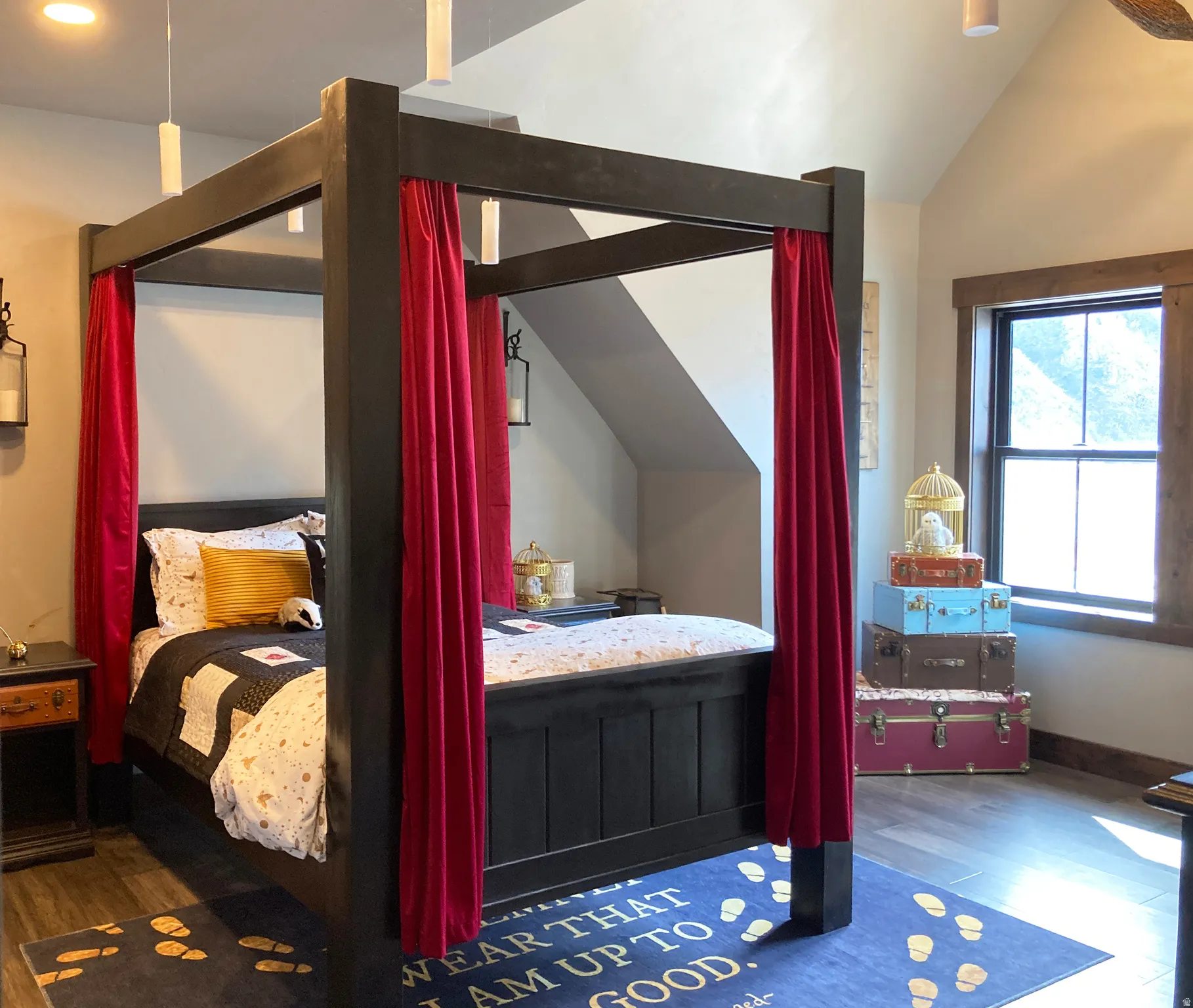 Bedroom with dark wood-style floors and lofted ceiling