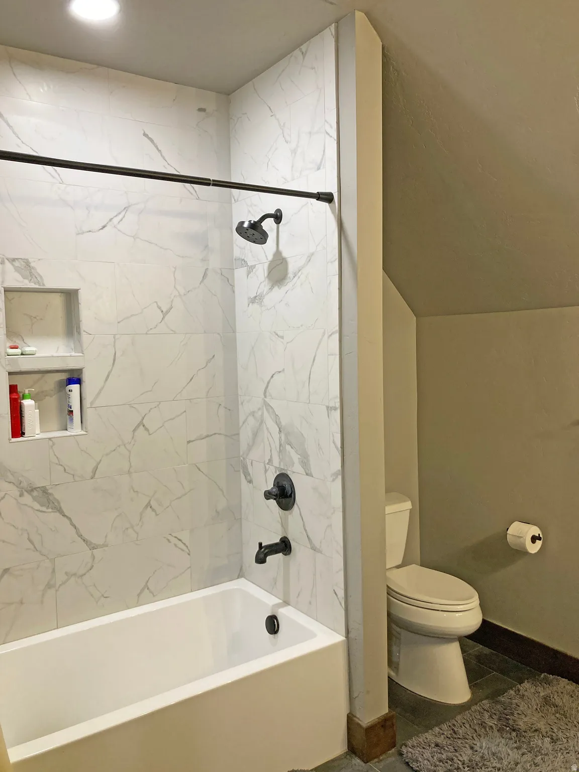 Bathroom with washtub / shower combination and vaulted ceiling