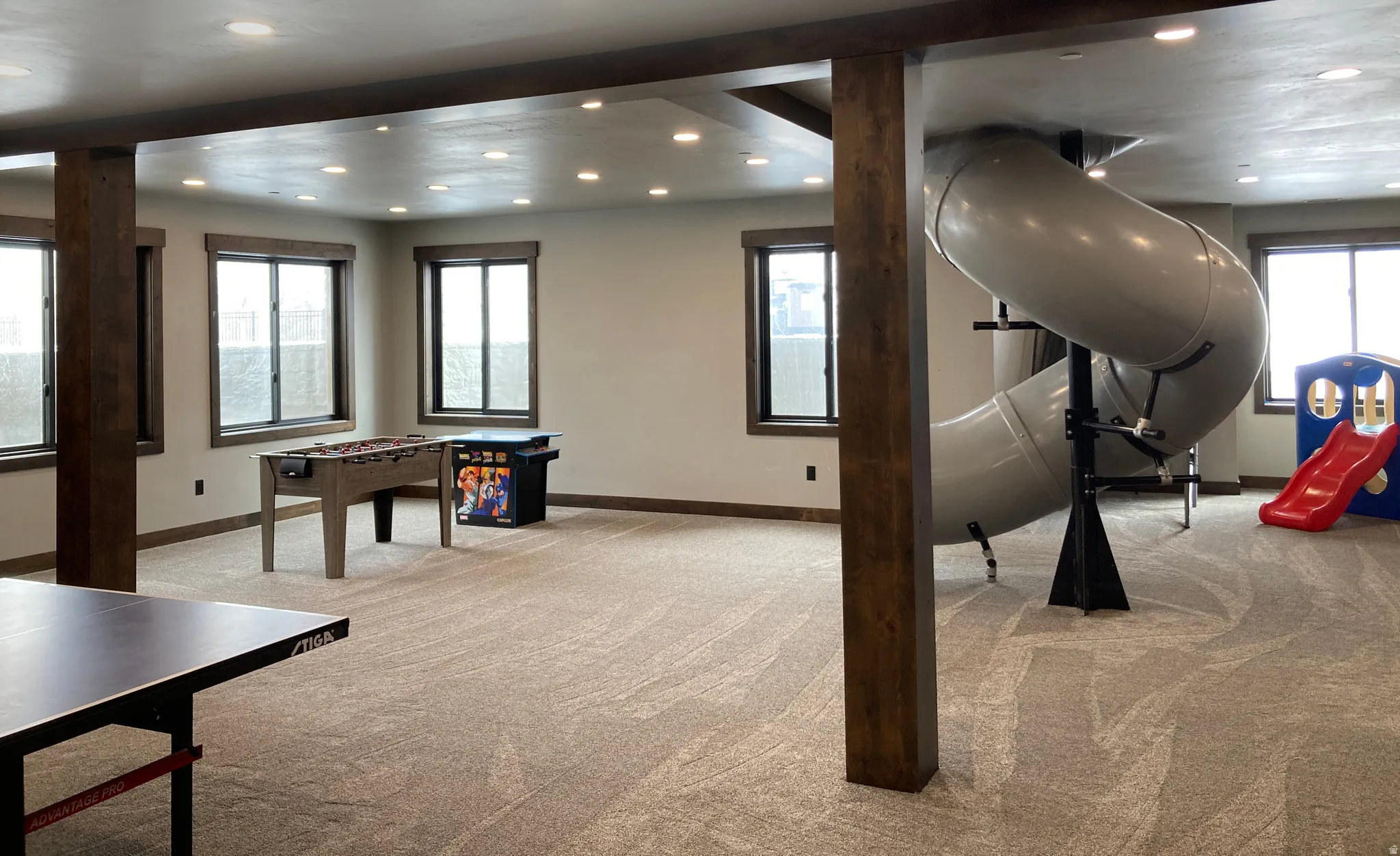 Rec room with recessed lighting, light colored carpet, and plenty of natural light